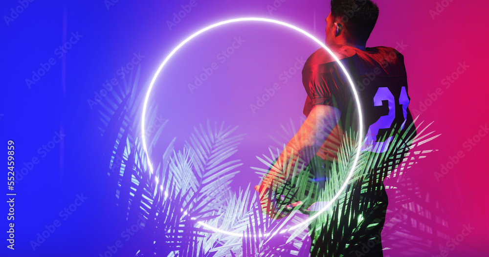 Side view of american football player in 21 number jersey standing by illuminated plants and circle Side view of american football player in 21 number jersey standing by illuminated plants and circle