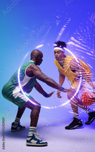 African american basketball players dribbling ball by illuminated circle and plants, copy space