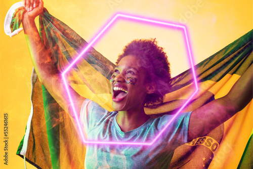 Hexagon neon over cheerful african american fan with flag celebrating victory during soccer match