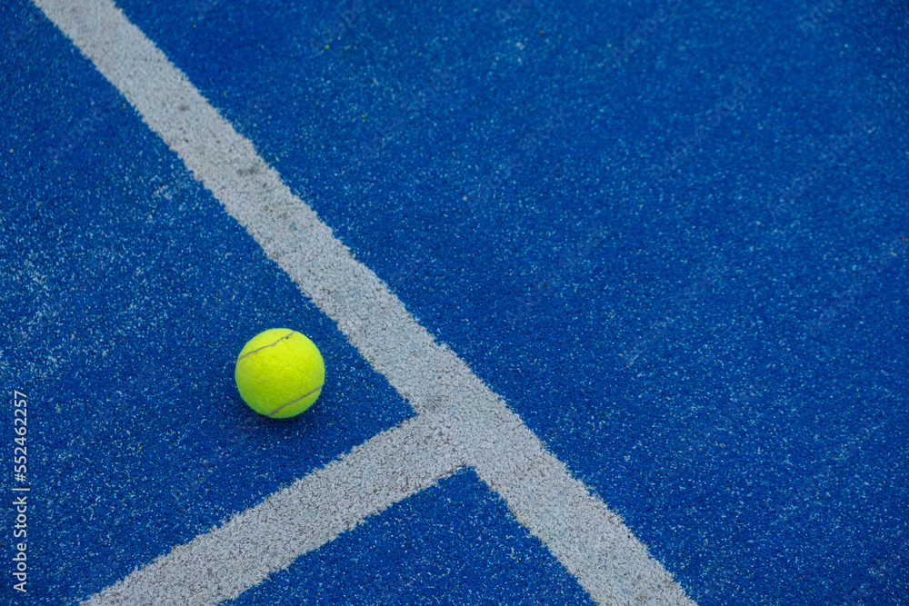 a ball on a paddle tennis court where the lines intersect