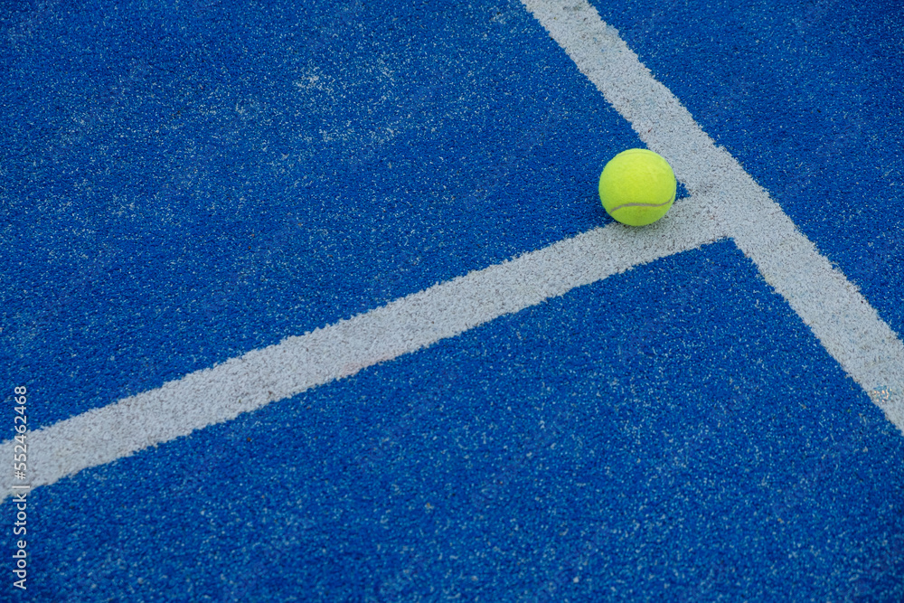 a ball on a blue paddle court where the lines connect
