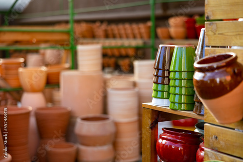 Rows with clay pots for plants in garden store