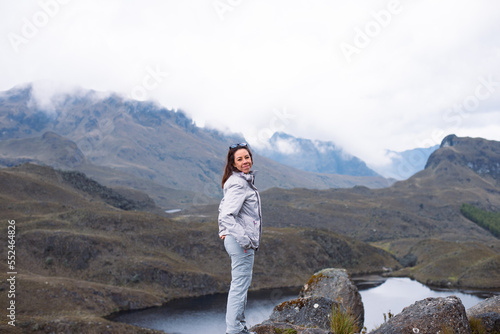 Girl on top the mountain smile with a clouds of background
