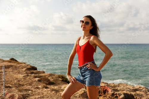 Portrait of a woman on the beach, ocean, unity with nature, healthy lifestyle