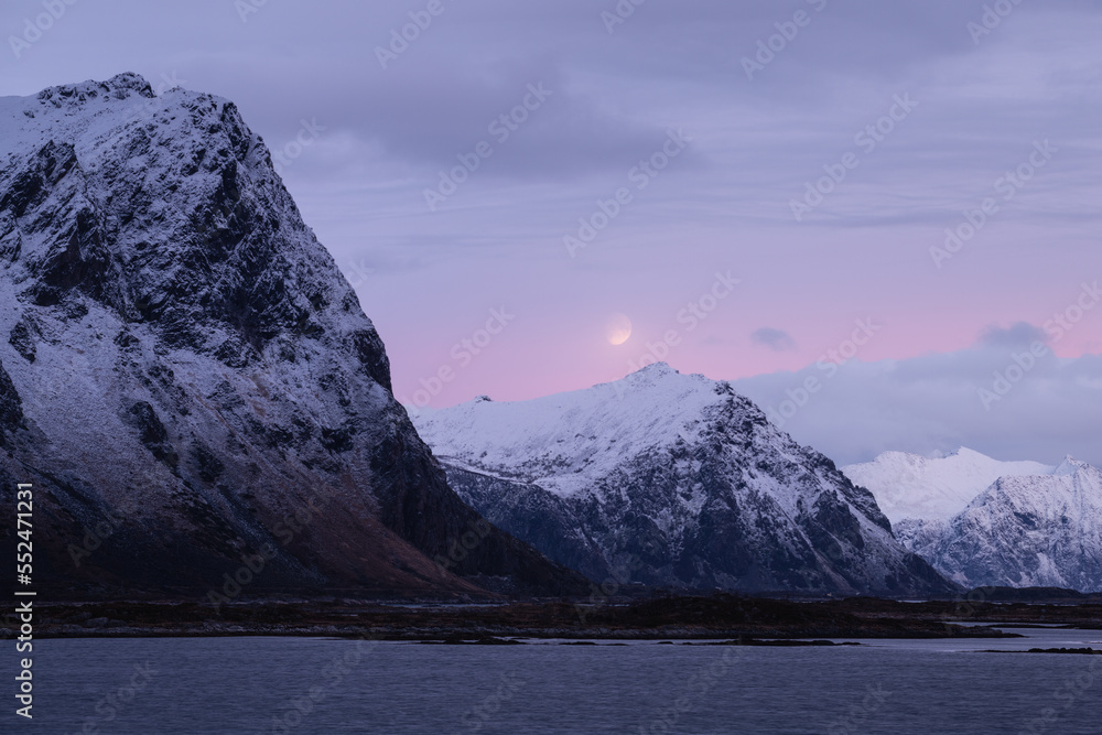 Moon over mountain peaks in December twilight, Lofoten Islands, Norway