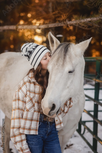 Teen Girl kissing White Horse in sunset © Cavan