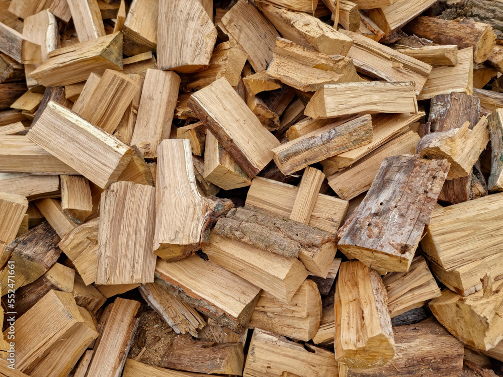 Chopped down tree trunks, firewood stacked in a storage yard, for heating in winter. Selective focus Chopped down tree trunks, firewood stacked in a storage yard, for heating in winter. Selective focus