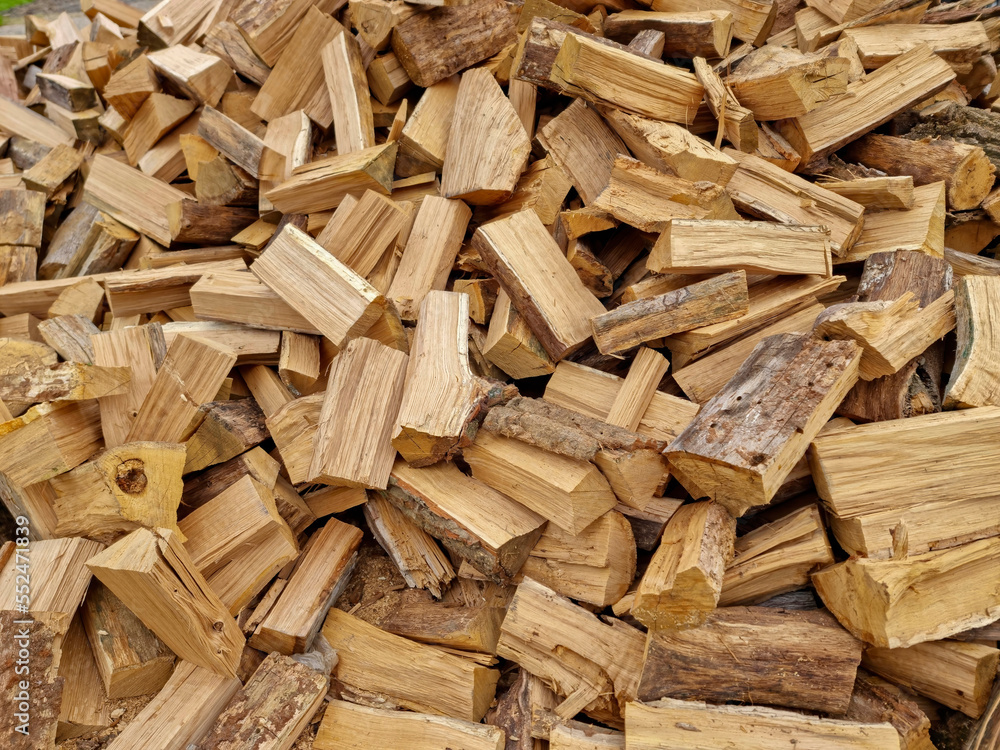 Chopped down tree trunks, firewood stacked in a storage yard, for heating in winter. Selective focus Chopped down tree trunks, firewood stacked in a storage yard, for heating in winter. Selective focus
