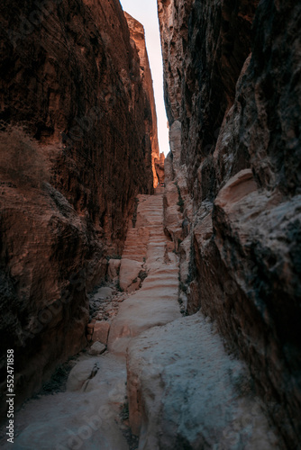 ancient steps pass through a sandstone alleyway in the Middle East where bedouin tribes would walk to the mountain. The photo is in Little Petra, Jordan 