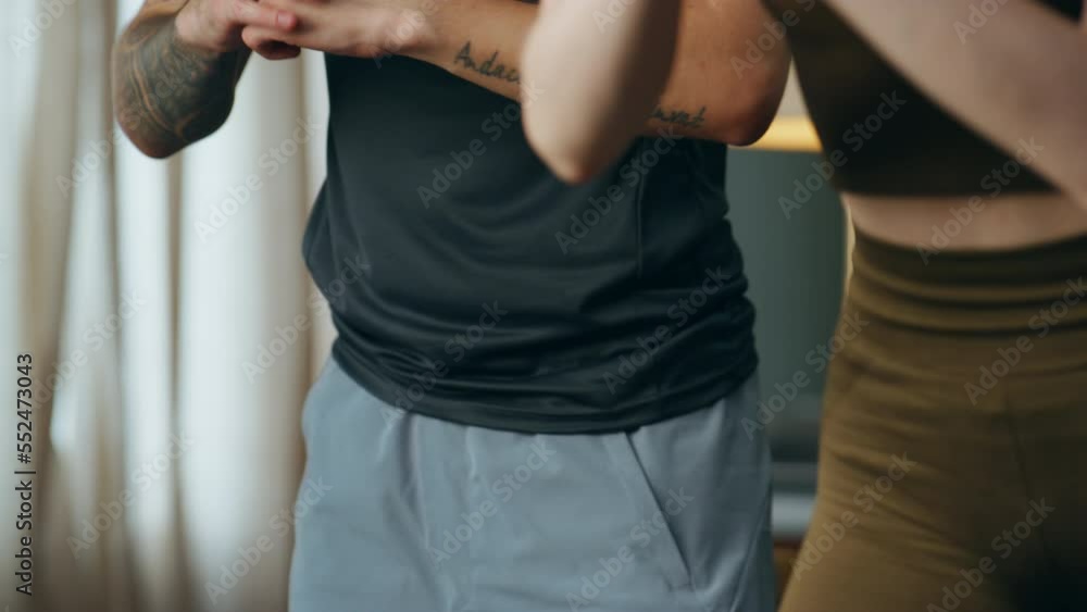Man training squats woman at home close up. Couple making fitness exercise. Man training squats woman at home close up. Couple making fitness exercise.