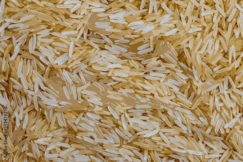Realistic vector illustration of long grain parboiled uncooked rice background. Rice groats as background and texture.
