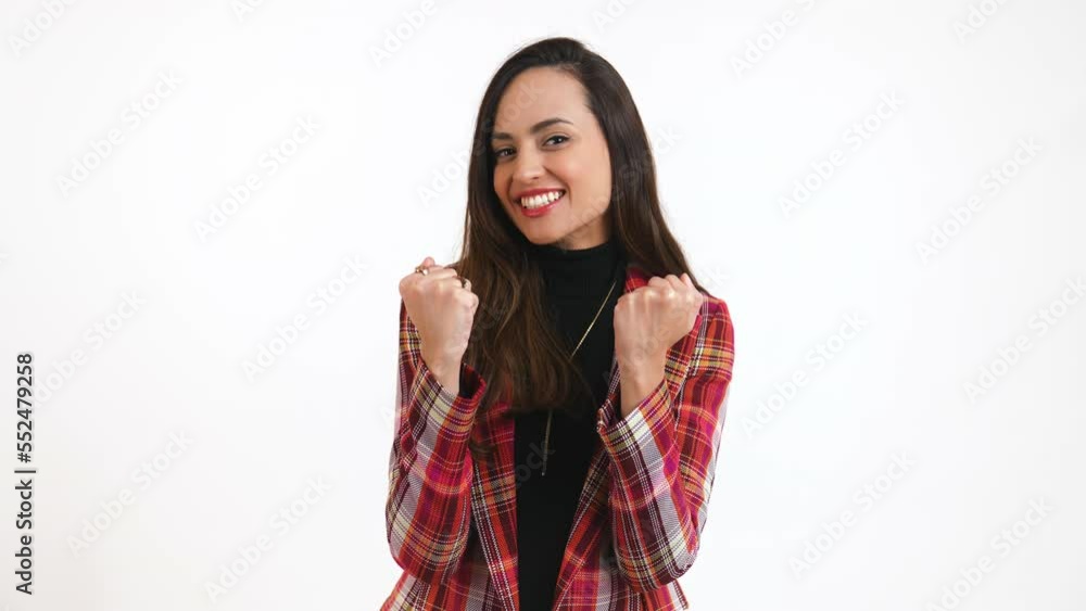 I made it, joyful Latin-American young woman holding her fists and expressing her happiness, medium shot white background. High quality 4k footage I made it, joyful Latin-American young woman holding her fists and expressing her happiness, medium shot white background. High quality 4k footage