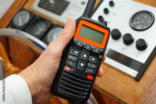 Handheld VHF held to transmit a message from the water and sea. For pleasure craft to call for help if there is a mayday or Panpan or securete to call the rescue service. photo