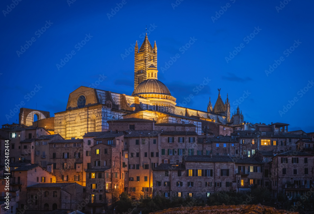 Beautiful panoramic view of the historic city of Siena at the night. Tuscany, Italy. October 2022