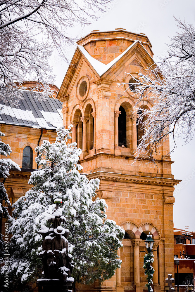 Fototapeta premium Snowy winter scene in Santa Fe, vertical view of church and trees