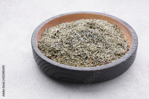 Plate with dried thyme on grey table, closeup