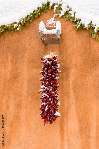 Christmas scene of snow-covered red chile ristra in Santa Fe, NM photo