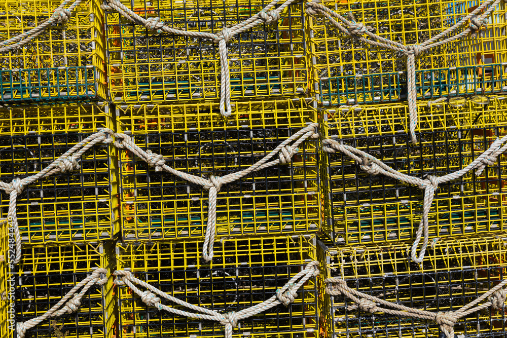 yellow lobster traps stacked on pier, Rockport, Massachusetts, USA