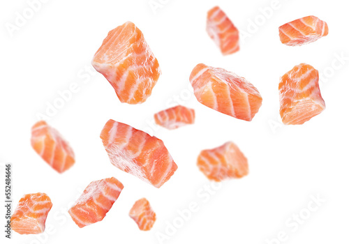 Pieces of fresh raw salmon flying on white background