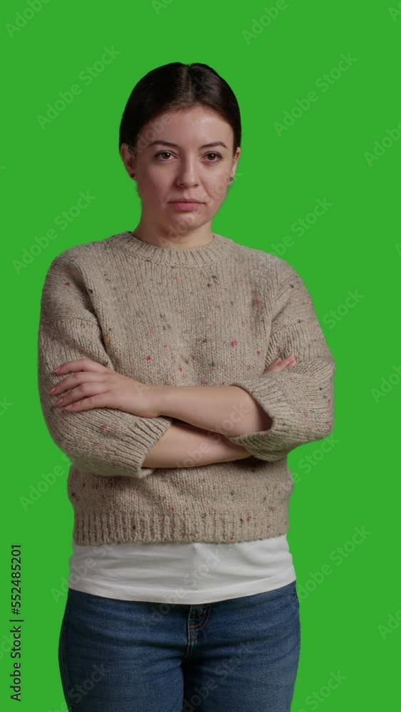 Vertical video: Front view of close up woman posing over greenscreen background, standing on green screen isolated template. Female model looking natural and confident, acting optimistic and smiling Vertical video: Front view of close up woman posing over greenscreen background, standing on green screen isolated template. Female model looking natural and confident, acting optimistic and smiling