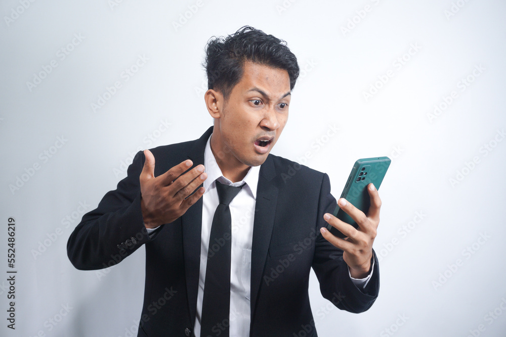 Mad male employee having smartphone problems or breakdown Mad male employee having smartphone problems or breakdown