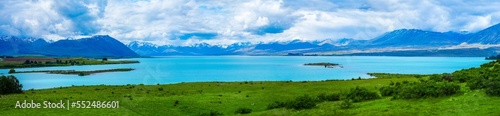 Panoramic view of the bright blue glacial water of Lake Tekapo