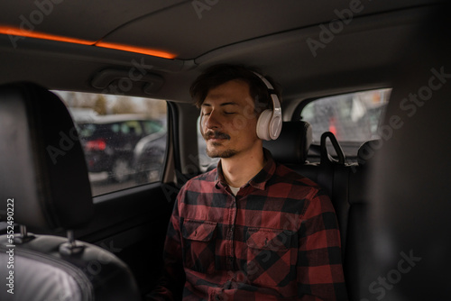 one man with headphones sit in the car listen guided meditation © Miljan Živković