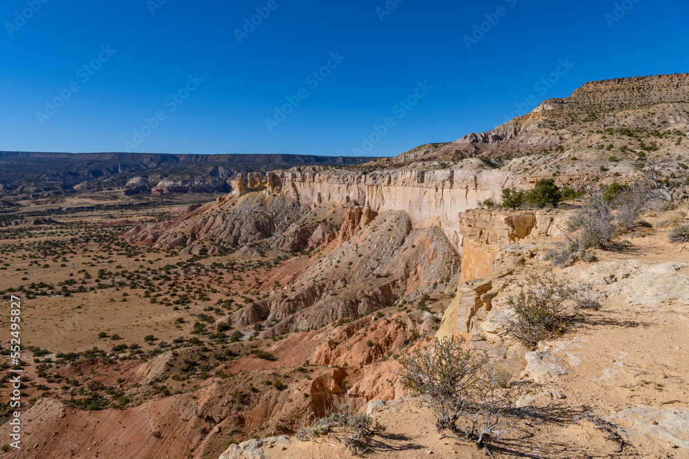 Wide view of desert landscape of colorful cliffs and rock formations in Ghost Ranch, New Mexico