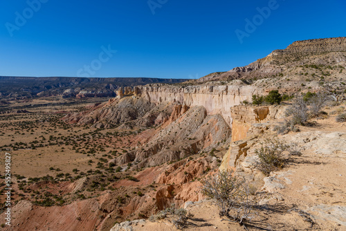 Wide view of desert landscape of colorful cliffs and rock formations in Ghost Ranch, New Mexico