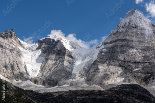 Mountainsof Daocheng Yading, Sichuan, China. Mt. Chenrezig (Xiannairi), with an altitude of 19,790 feet (6,032 meters), is the highest peak in Daocheng County. 