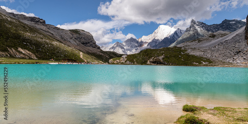 Panorama of Milk Lake Yading landscape at Yading national reserve. It is Beautiful lake clour like a milk blue. Daocheng County, Sichuan Province, China - hikes to epic mountains