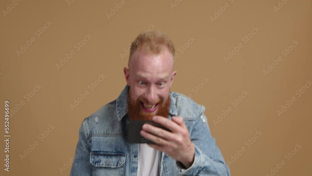 Caucasian man with happy and cheerful facial expression after winning a game. Close-up view of a male gamer playing an online competition. High quality 4k footage Caucasian man with happy and cheerful facial expression after winning a game. Close-up view of a male gamer playing an online competition. High quality 4k footage