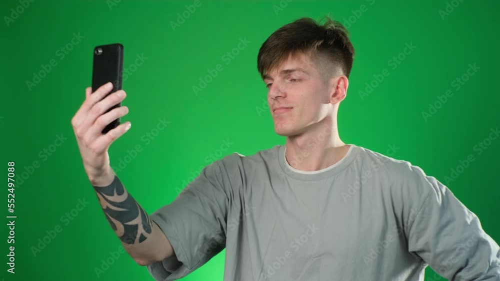Smiling man making video call on smartphone