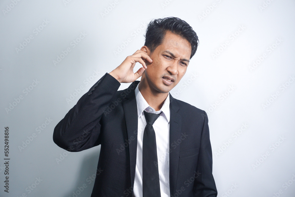 Unhealthy young asian man suffering from sudden throbbing ear ache. Unhealthy young asian man suffering from sudden throbbing ear ache.