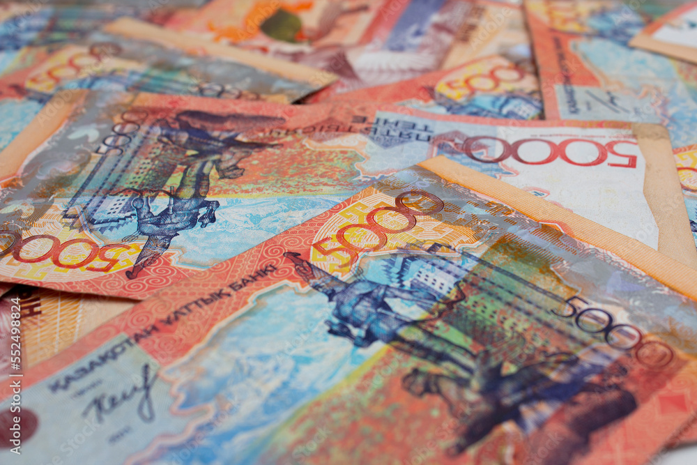 Background with paper banknotes of Republic of Kazakhstan. 5000 Kazakh tenge. Cash to pay for purchases. Money for travel, tourism, adventure. Currency exchange before the trip. Salary, loan repayment