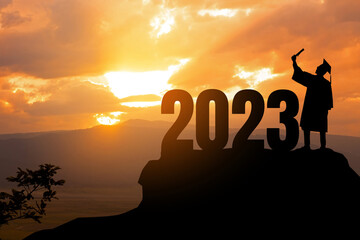 Silhouette Young man Graduation in 2023 years, education congratulation concept, Freedom and Happy new year, success in the future goal and passing time.copy space.