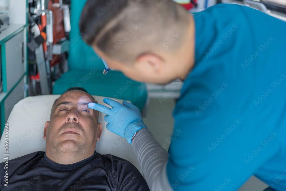 Top view of a doctor examining a patient in an ambulance Top view of a doctor examining a patient in an ambulance