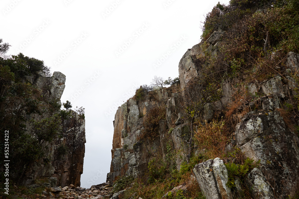 Gap in coastal rocky headland landscape on overcast morning Gap in coastal rocky headland landscape on overcast morning