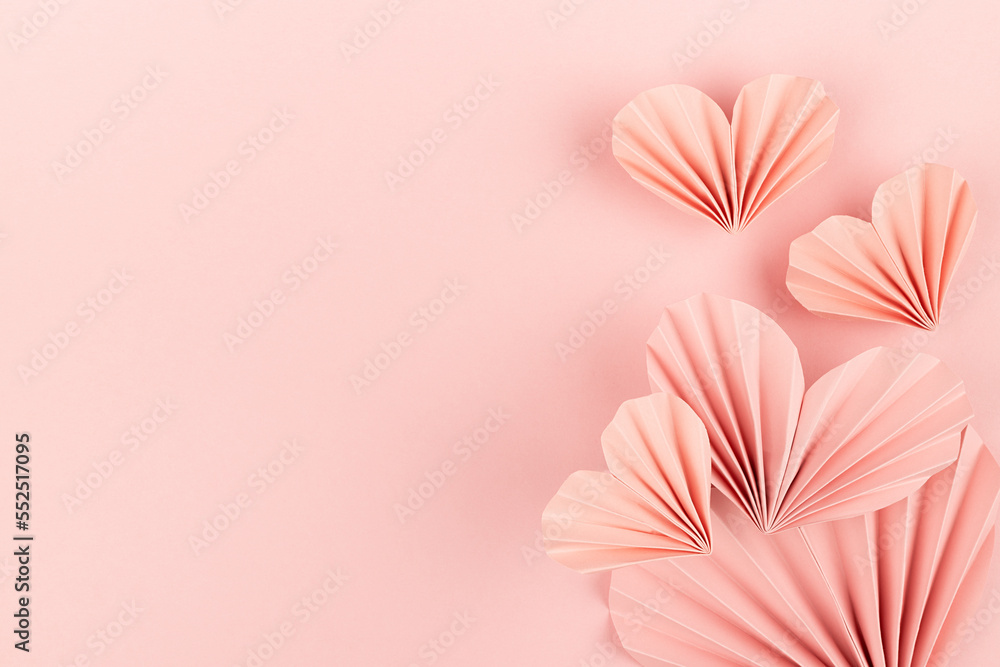 Elegant soft pink paper ribbed hearts in oriental origami style as soar