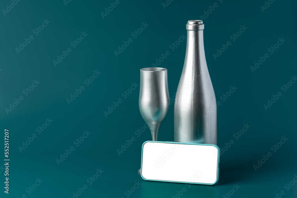 Beautiful picture of a bottle of champagne and glass on dark green background Beautiful picture of a bottle of champagne and glass on dark green background