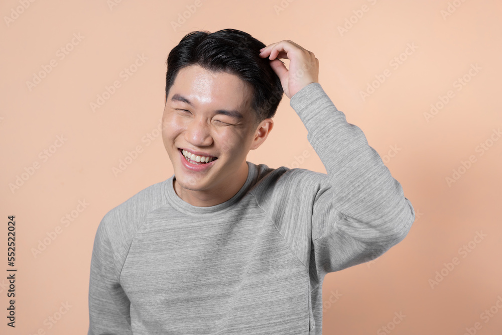 Portrait of handsome man with beaming smile touching his hair Portrait of handsome man with beaming smile touching his hair