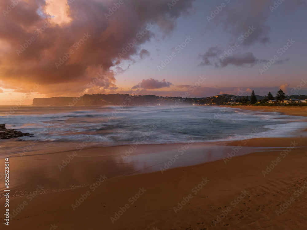 Surfs up sunrise at the seaside with scattered clouds