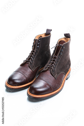 Footwear Ideas. Pair of Premium Dark Brown Grain Brogue Derby Boots Made of Calf Leather with Rubber Sole Placed in Line Together Over White Background.