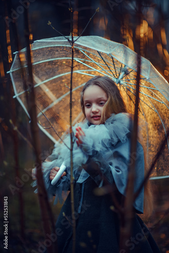 Girl with umbrella in the night forest