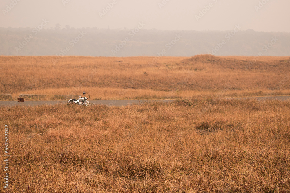 vast grasslands of Meghalaya, India with a motorcycle in backgroung vast grasslands of Meghalaya, India with a motorcycle in backgroung