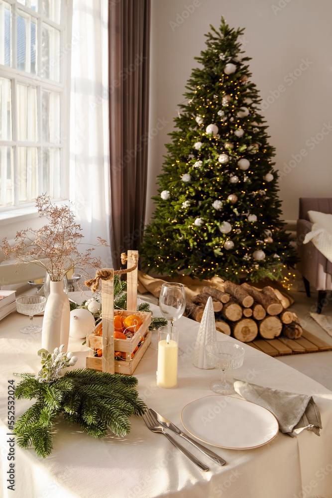 Beautiful table setting with Christmas decorations in living room. Dinner or lunch