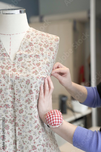 Tailor woman sewing beautiful dress