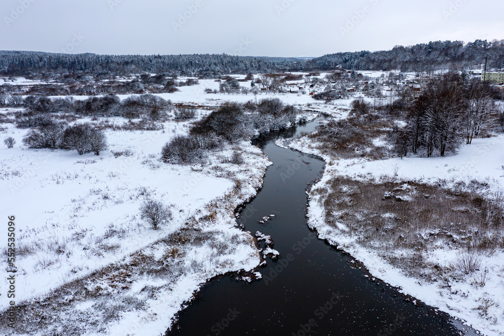 Panoramic Latvian winter landscape with Abava river flowing through the plain near Kandava