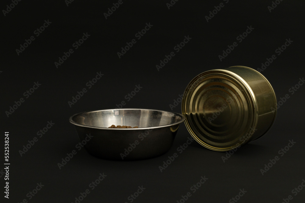 Canned food in a tin on a black background Canned food in a tin on a black background
