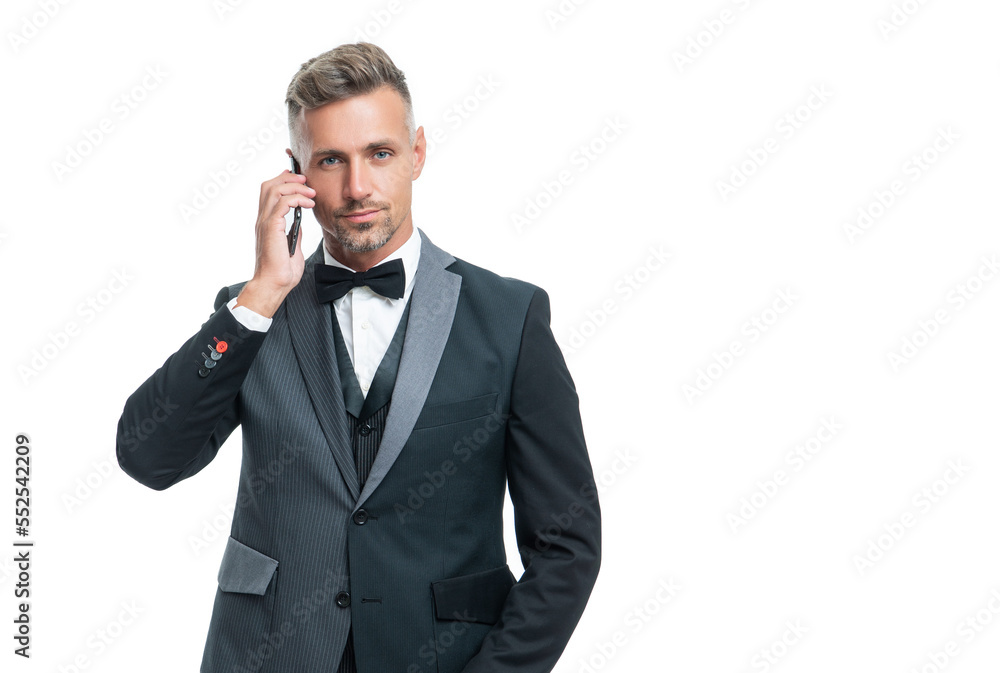 entrepreneur in tuxedo speak on smartphone isolated on white background entrepreneur in tuxedo speak on smartphone isolated on white background